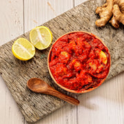 Swaadrani traditional homemade Lemon Pickle (Nimbu Achar) made with fresh chopped lemons, traditional Indian spices, and cold-pressed oil in a bowl.