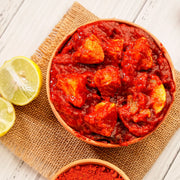 Swaadrani traditional homemade Lemon Pickle (Nimbu Achar) made with fresh chopped lemons, traditional Indian spices, and cold-pressed oil in a bowl.
