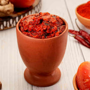 Swaadrani tomato pickle served in a bowl