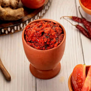 Swaadrani tomato pickle served in a bowl